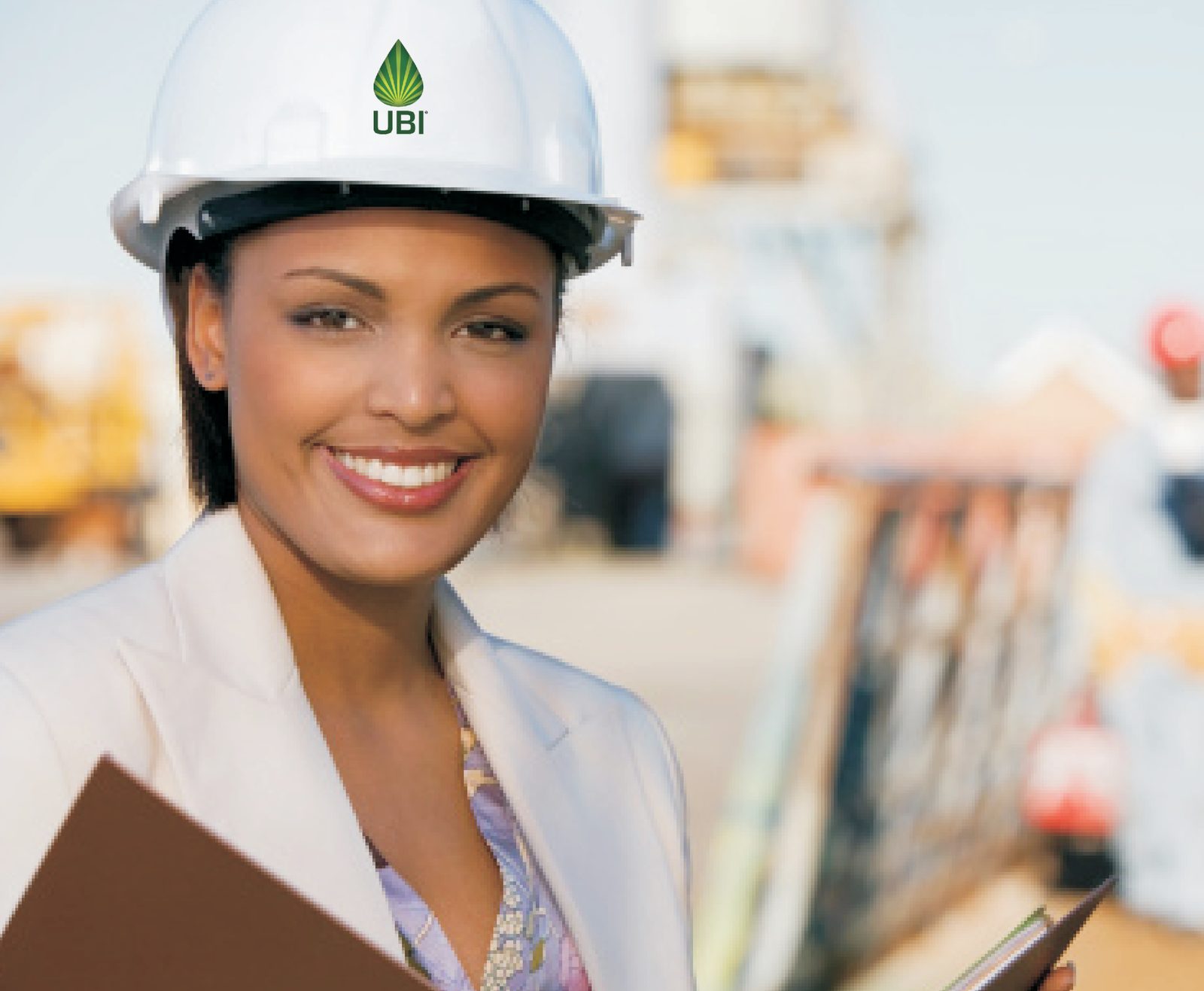 UBI engineer in a branded hard hat on an industrial site