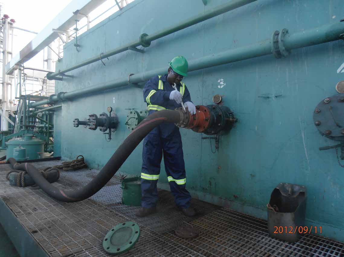 Hargis crew member connecting a bunker hose on deck
