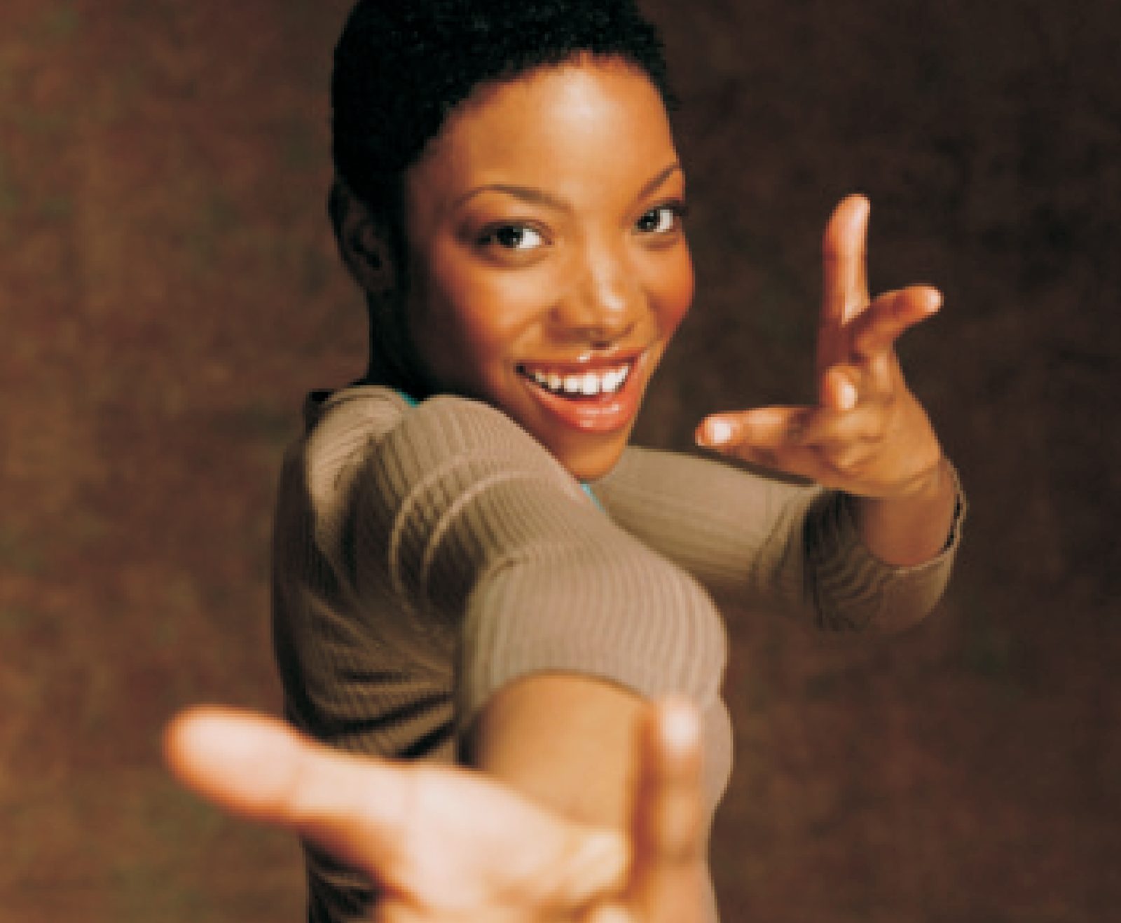 Smiling young professional reaching toward the camera